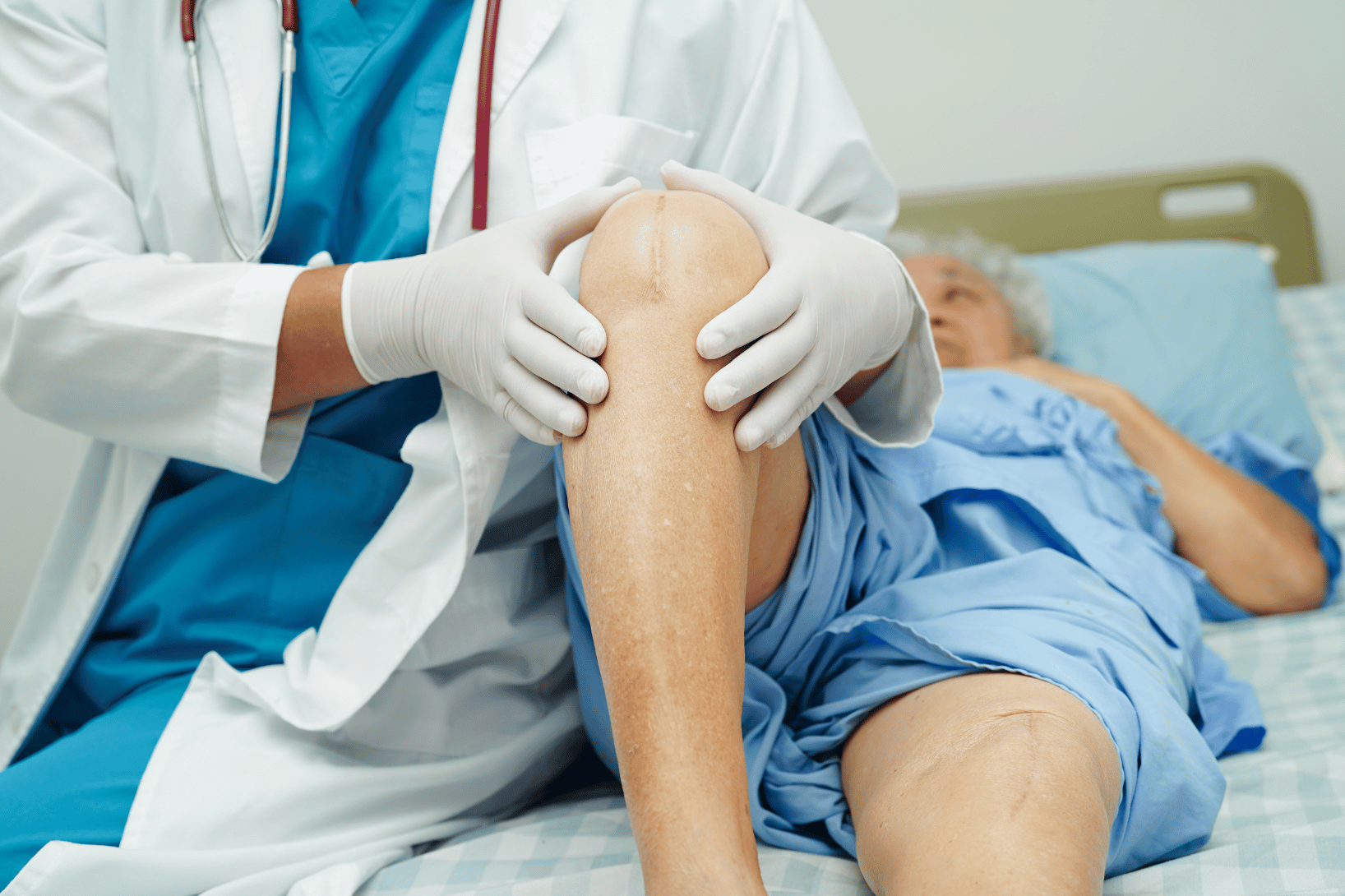 Doctor evaluating patient's medical device knee replacement