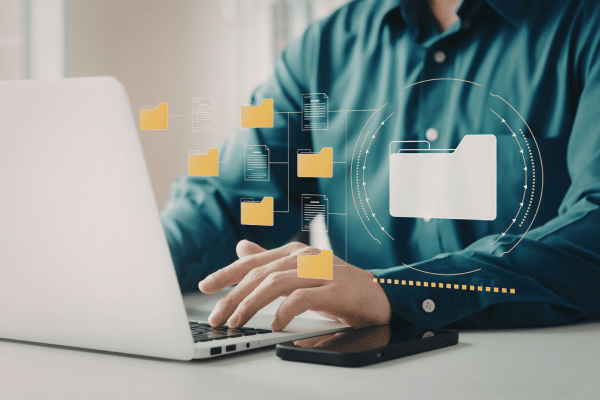 person using laptop to manage files electronically